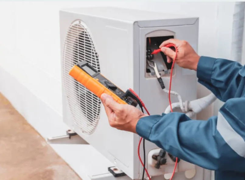 Technician testing an outdoor HVAC unit during an airflow system evaluation