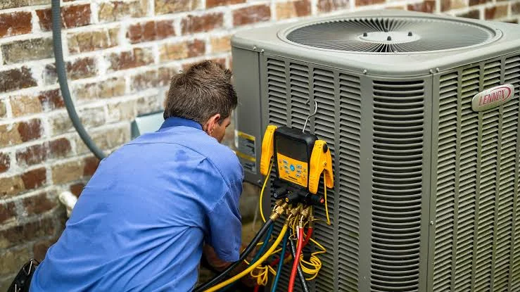 HVAC technician servicing a residential outdoor air conditioning unit