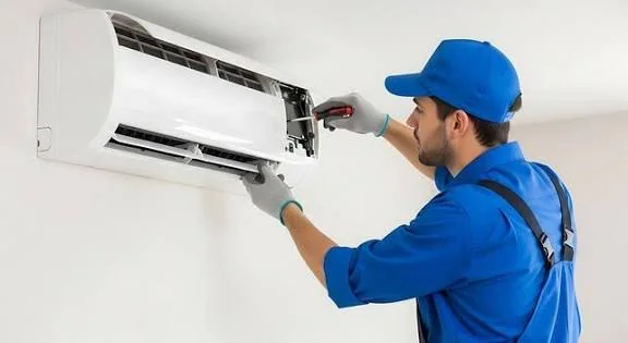 Technician documenting an inspection of outdoor HVAC units